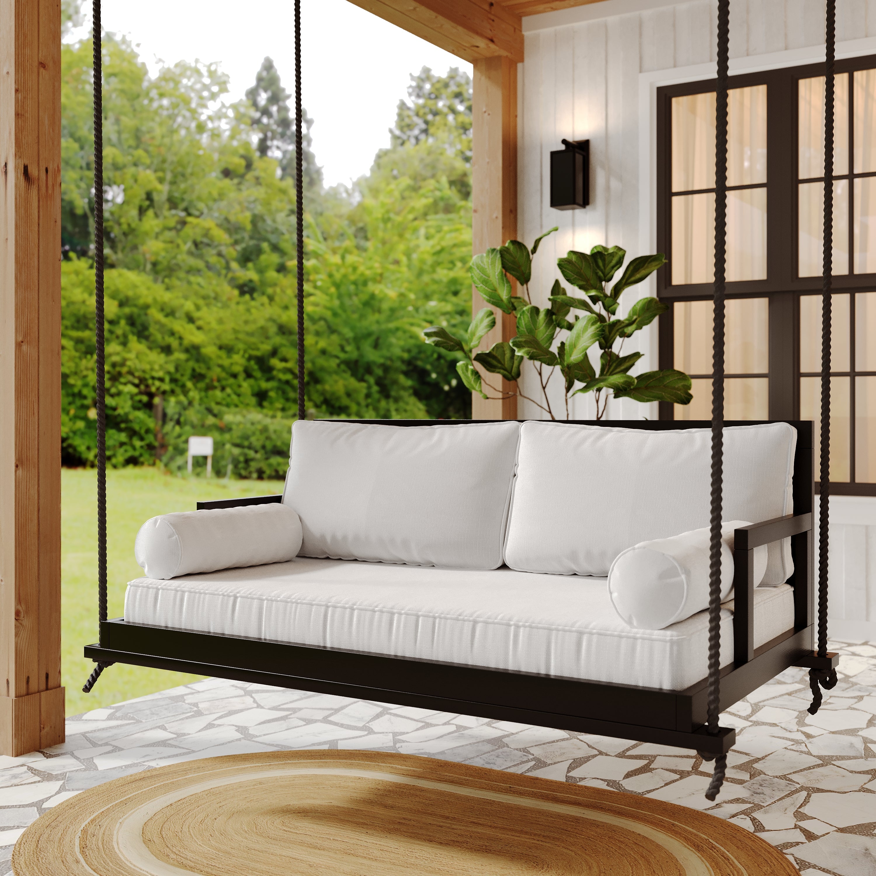 Black porch swing bed with white mattress and pillows