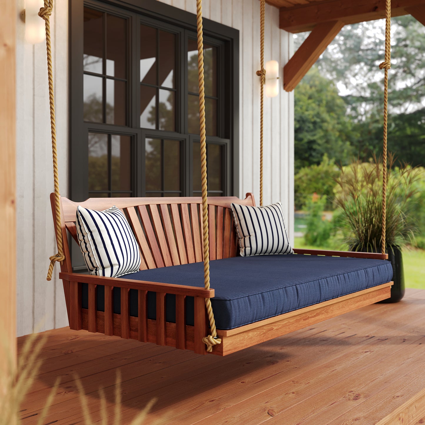 Sunburst Red Cedar Swing Bed in Cedar Stain pictured with Canvas Navy Mattress and Lido Indigo Pillows